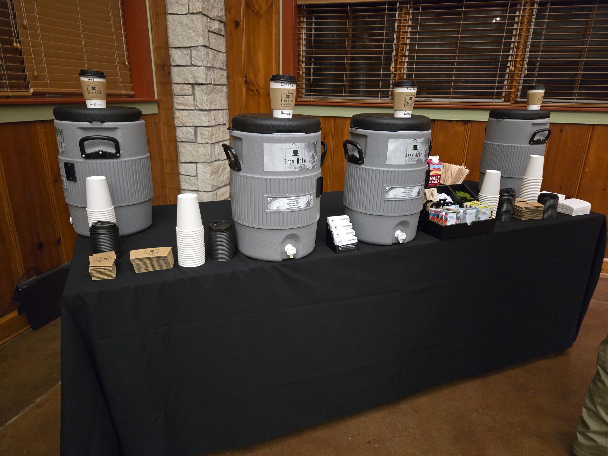 Brew Haha drink catering setup with cambros, cups, half & half, and sugars